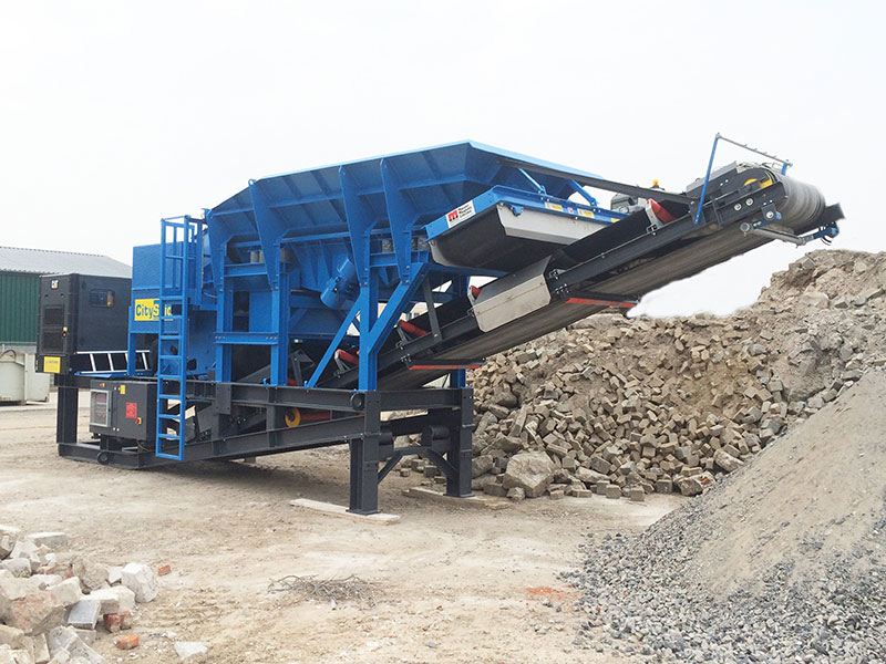 The CitySkid 960V crusher between rock piles.